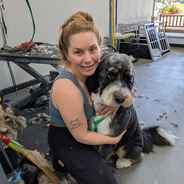 Amanda, owner of Country Pet Wash, with a freshly groomed doodle